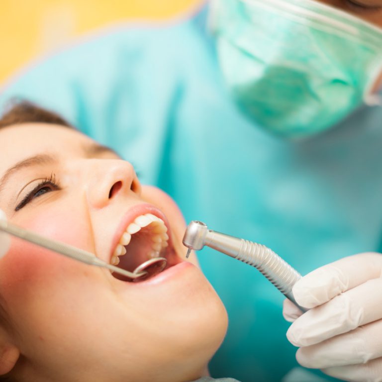 Dentist,Doing,A,Dental,Treatment,On,A,Female,Patient